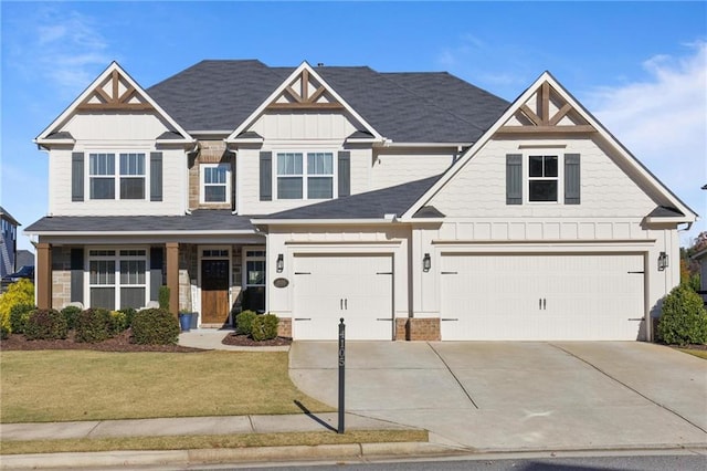 craftsman inspired home with a garage and a front lawn