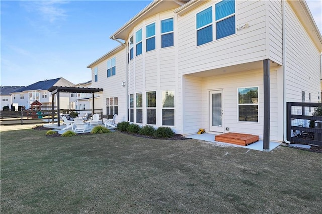 rear view of property with a yard and a patio area