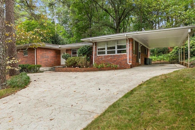 view of front facade with a front yard and a carport