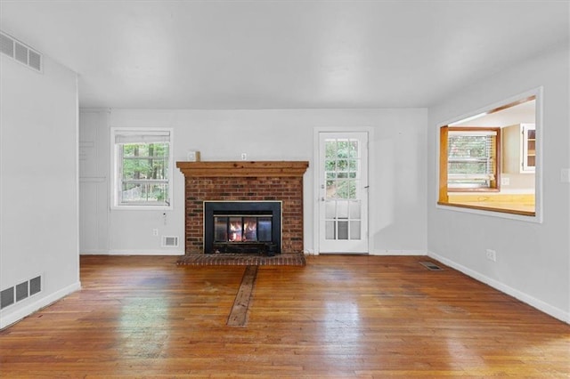 unfurnished living room featuring hardwood / wood-style floors and a fireplace