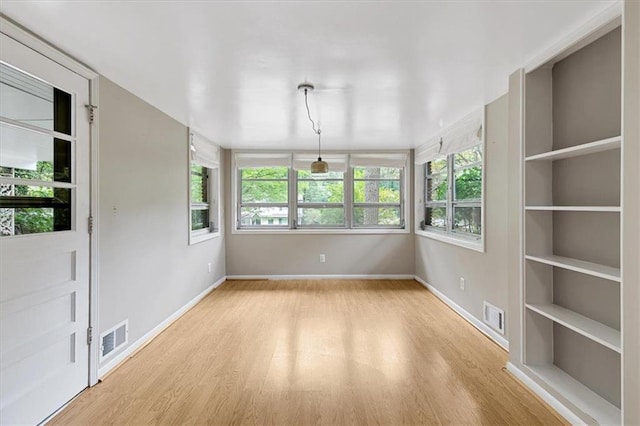 empty room with light hardwood / wood-style flooring