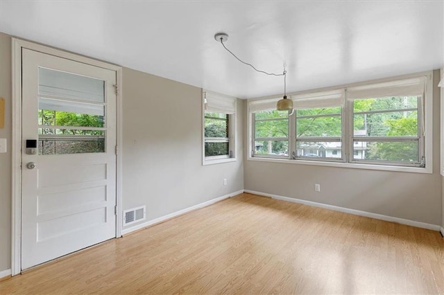 empty room with light hardwood / wood-style floors