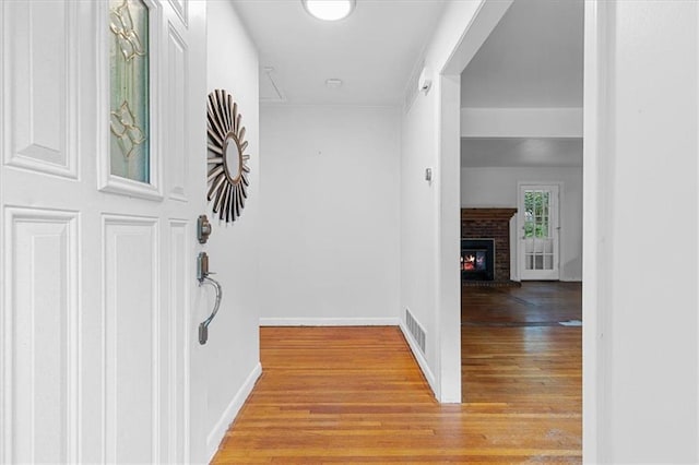 corridor with light hardwood / wood-style flooring