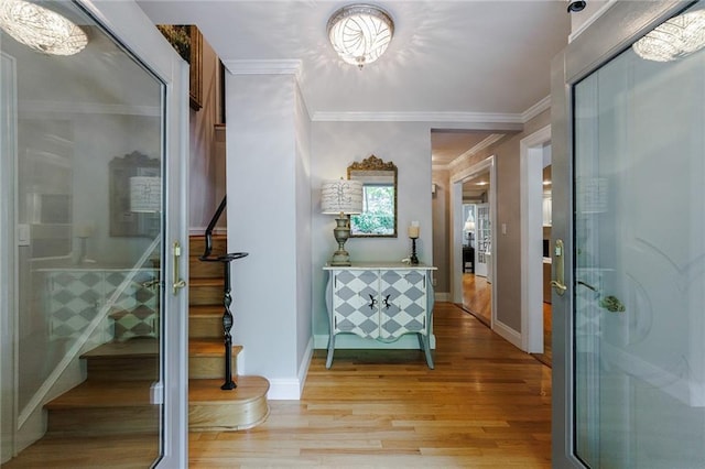 interior space featuring crown molding and light hardwood / wood-style flooring