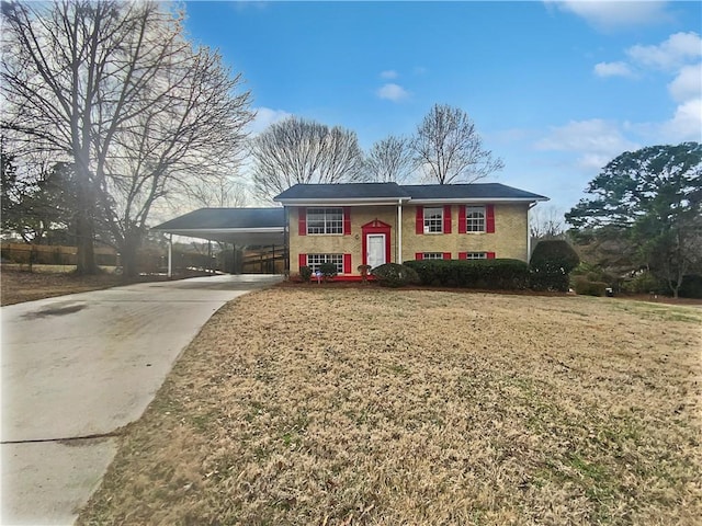 bi-level home featuring a front yard and a carport