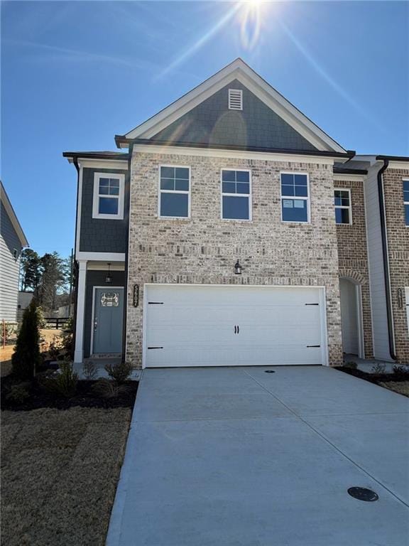 view of front of home featuring brick siding, concrete driveway, and an attached garage