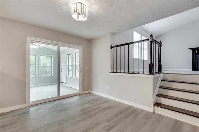 interior space with hardwood / wood-style flooring and a textured ceiling