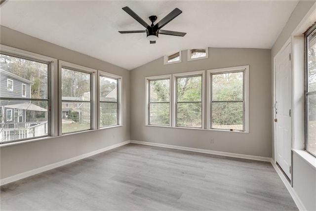 unfurnished sunroom featuring a wealth of natural light, lofted ceiling, and ceiling fan