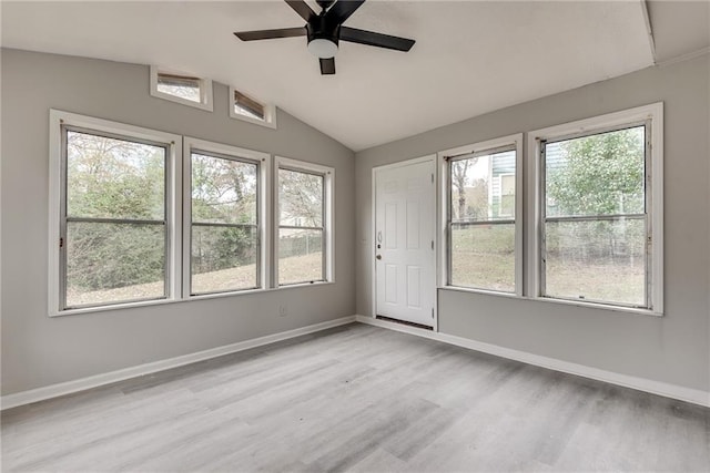 interior space with a wealth of natural light, lofted ceiling, and light wood-type flooring