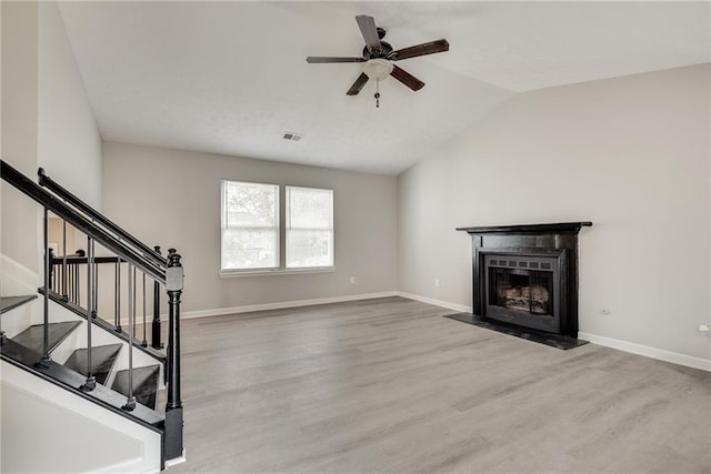 unfurnished living room with hardwood / wood-style flooring, ceiling fan, and lofted ceiling