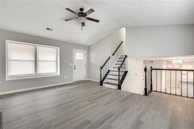 entrance foyer featuring ceiling fan, light wood-type flooring, and lofted ceiling