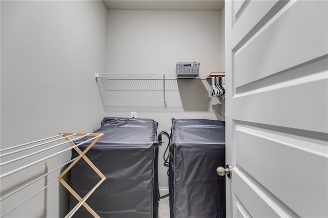 clothes washing area with washer and clothes dryer