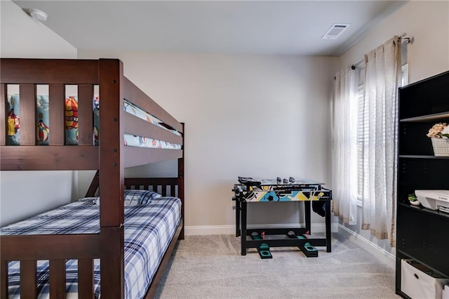 carpeted bedroom featuring multiple windows