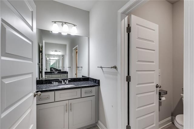 bathroom with toilet and vanity