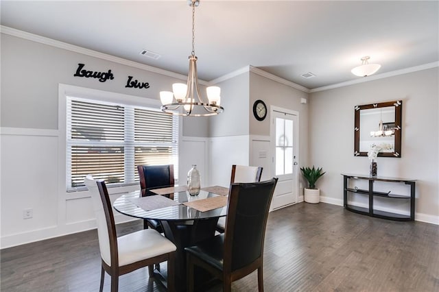 dining area featuring a chandelier, dark hardwood / wood-style flooring, and ornamental molding