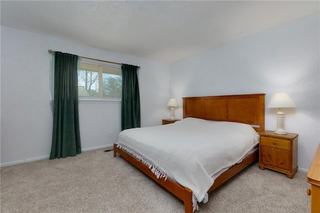 bedroom featuring baseboards and light colored carpet