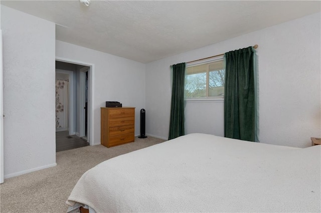 bedroom with carpet flooring and baseboards