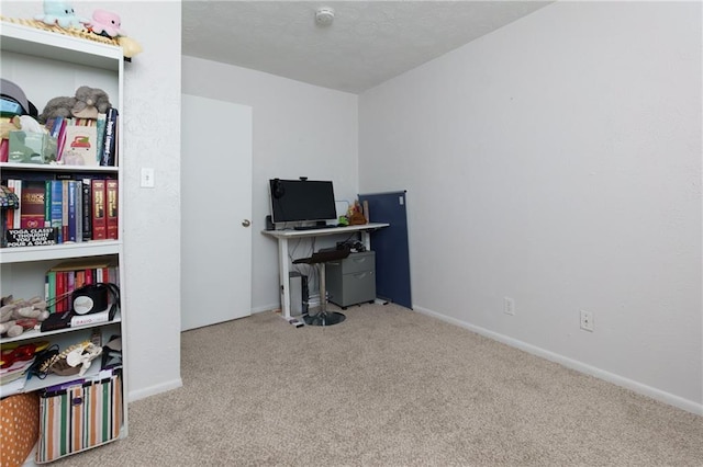 carpeted office featuring baseboards