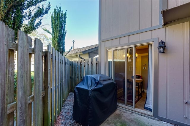 view of patio / terrace with a grill and fence