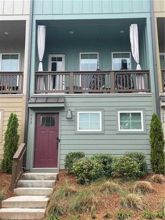 exterior space featuring a balcony and board and batten siding