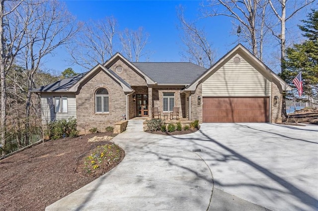 ranch-style home featuring a garage, concrete driveway, and brick siding