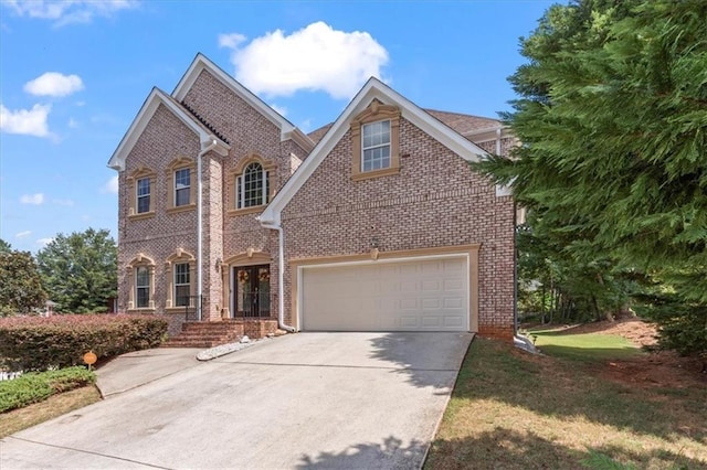 view of front of property with a garage, concrete driveway, and brick siding