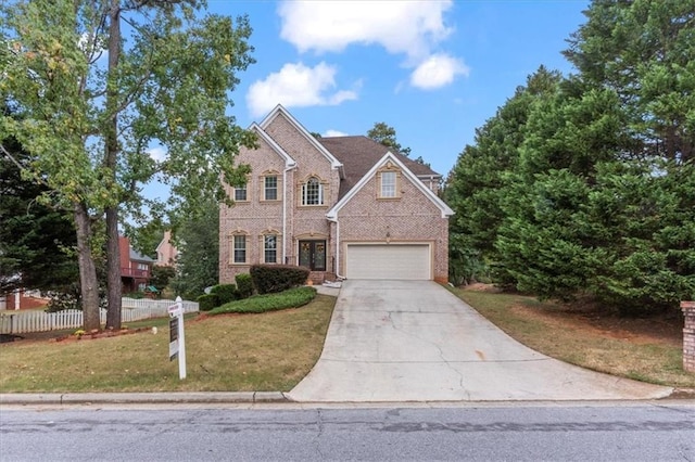 view of front of property featuring brick siding, fence, concrete driveway, and a front yard