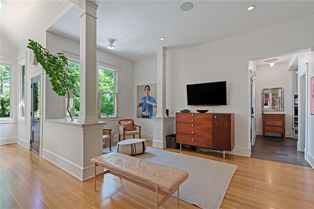 living room with recessed lighting, ornate columns, and wood finished floors