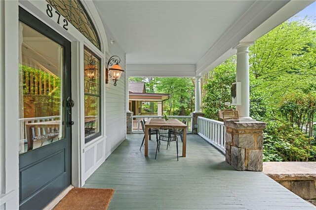 wooden terrace with a porch
