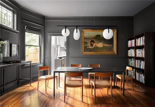 dining room featuring ornamental molding and hardwood / wood-style floors