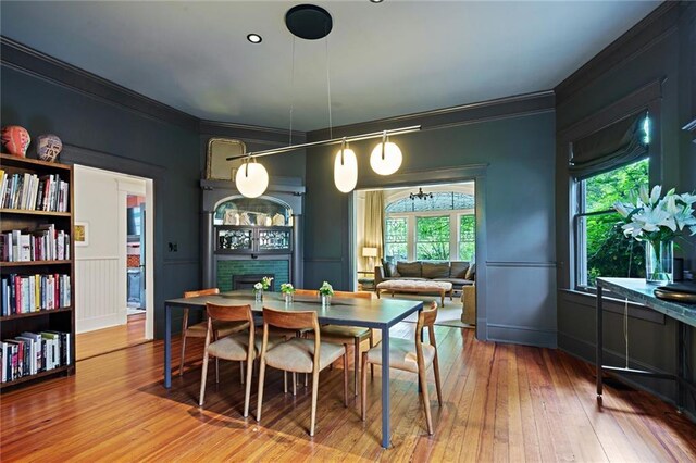 dining area featuring ornamental molding and hardwood / wood-style flooring