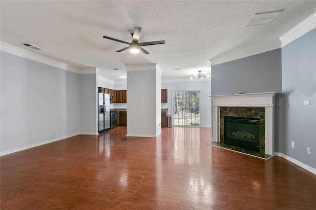 unfurnished living room with a fireplace, ceiling fan, dark wood-type flooring, and ornamental molding