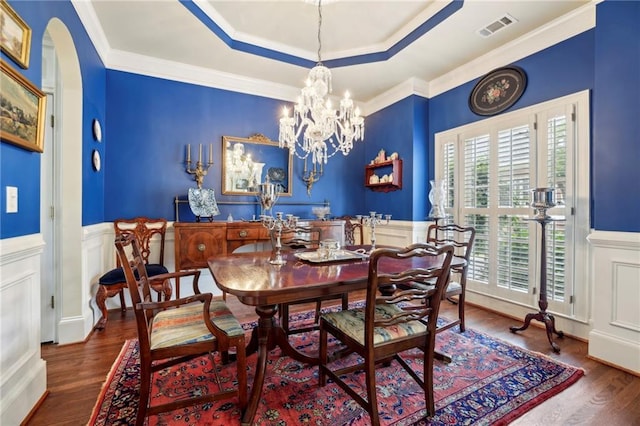 6259 Spalding Dr, Peachtree Corners, GA 30092 - dining space with wood finished floors, a wainscoted wall, crown molding, arched walkways, and a decorative wall