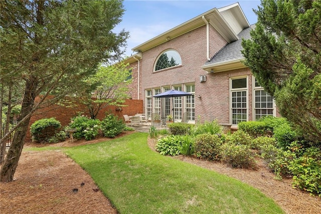 6259 Spalding Dr, Peachtree Corners, GA 30092 - rear view of house with a patio, brick siding, and a yard