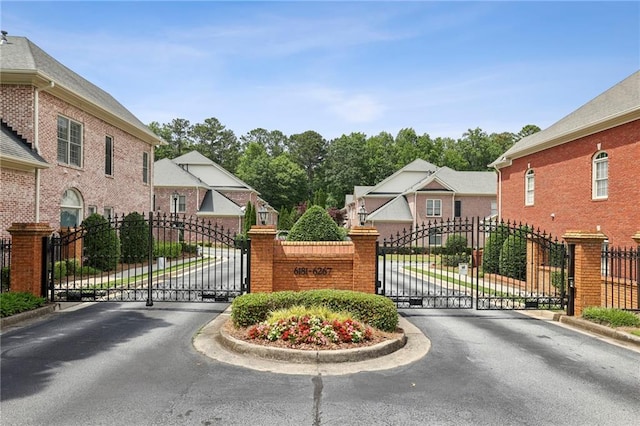 6259 Spalding Dr, Peachtree Corners, GA 30092 - view of asphalt street featuring a gate, a gated entry, and curbs