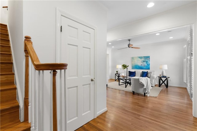 hall with crown molding and light hardwood / wood-style floors