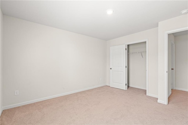 unfurnished bedroom with baseboards, recessed lighting, a closet, and light colored carpet