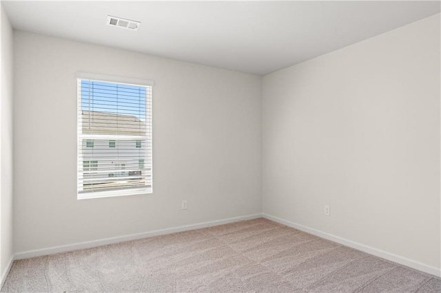 spare room featuring baseboards and carpet flooring