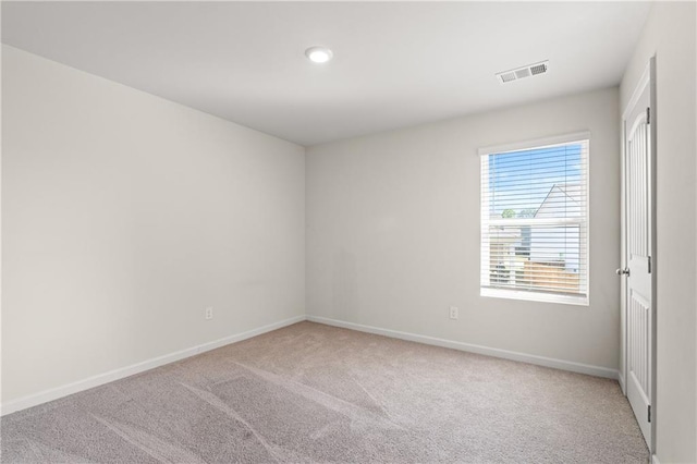 empty room featuring recessed lighting, carpet floors, visible vents, and baseboards