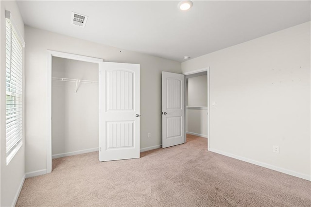 unfurnished bedroom featuring visible vents, carpet flooring, and baseboards
