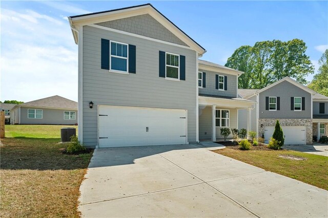 view of front of house with a garage, a front lawn, concrete driveway, and central AC unit