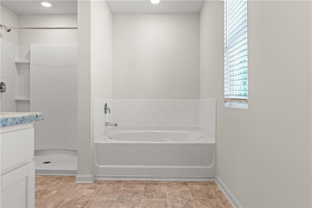 full bath featuring a bath, baseboards, vanity, and a shower stall