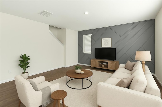 living area featuring dark wood-type flooring, visible vents, baseboards, and recessed lighting