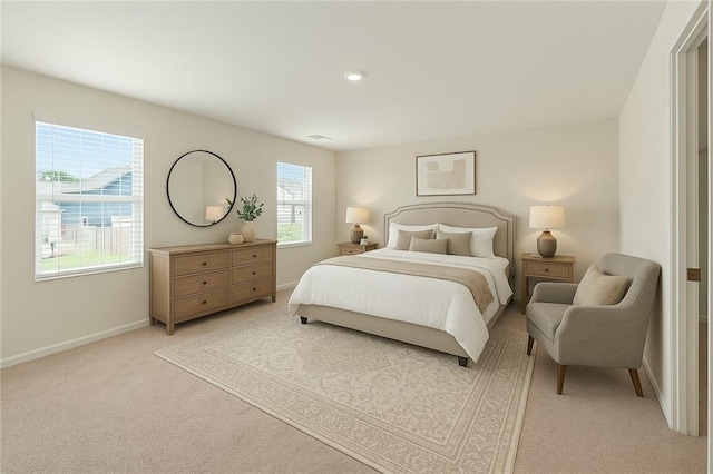 bedroom with light carpet and baseboards