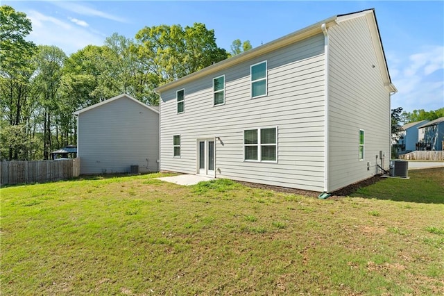 rear view of house with fence, a yard, central air condition unit, and a patio