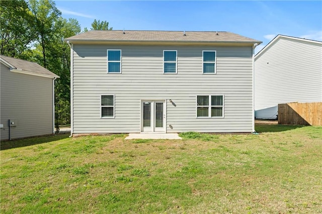 back of house with a yard and fence