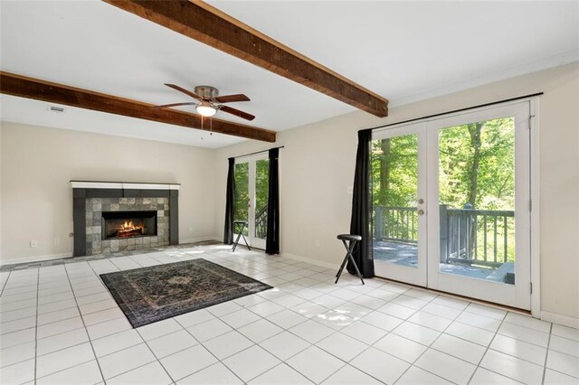 unfurnished living room with beamed ceiling, light tile patterned floors, plenty of natural light, and french doors