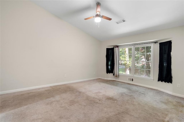 carpeted empty room featuring ceiling fan and lofted ceiling