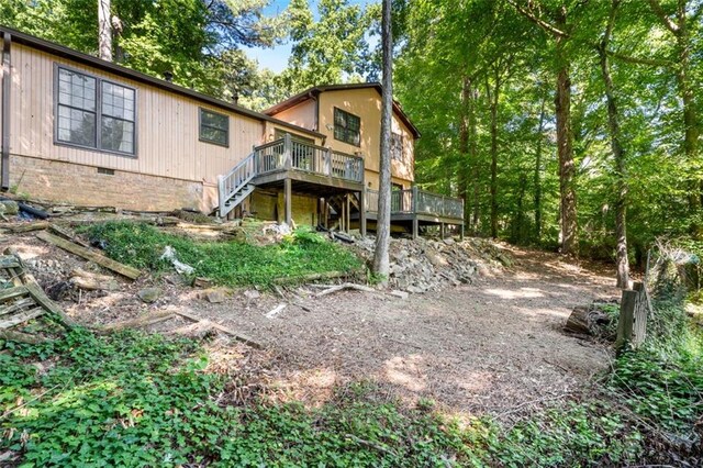 back of house featuring a wooden deck