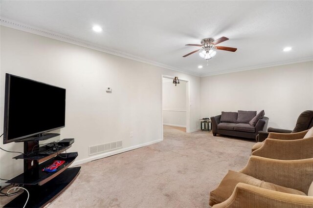 living room with ceiling fan, carpet, and crown molding